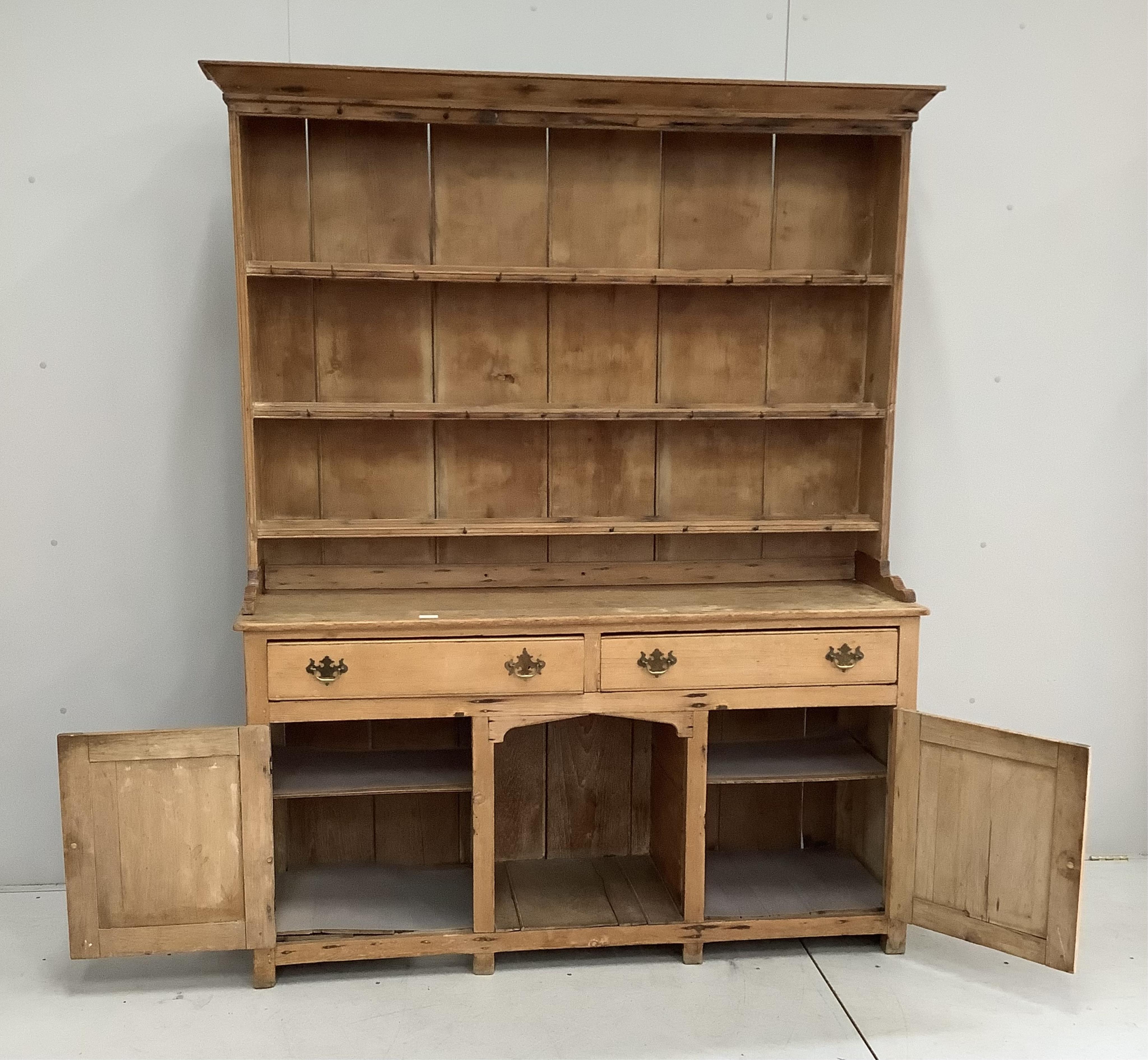 A Victorian stripped pine 'dog kennel' dresser with boarded rack, width 156cm, depth 44cm, height 200cm
